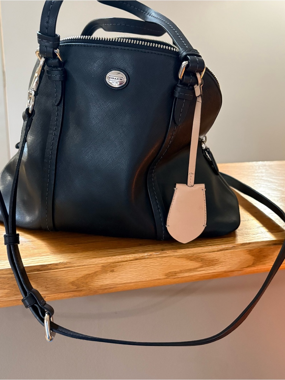 Black Saffiano Leather Coach Peyton Cora domed satchel.